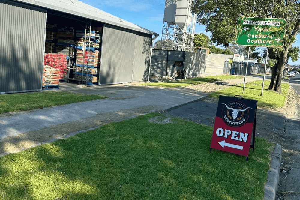 In-store or online_ Yass Valley Stockfeeds storefront with a sign welcoming customers, showing options for in-store pickup or online ordering